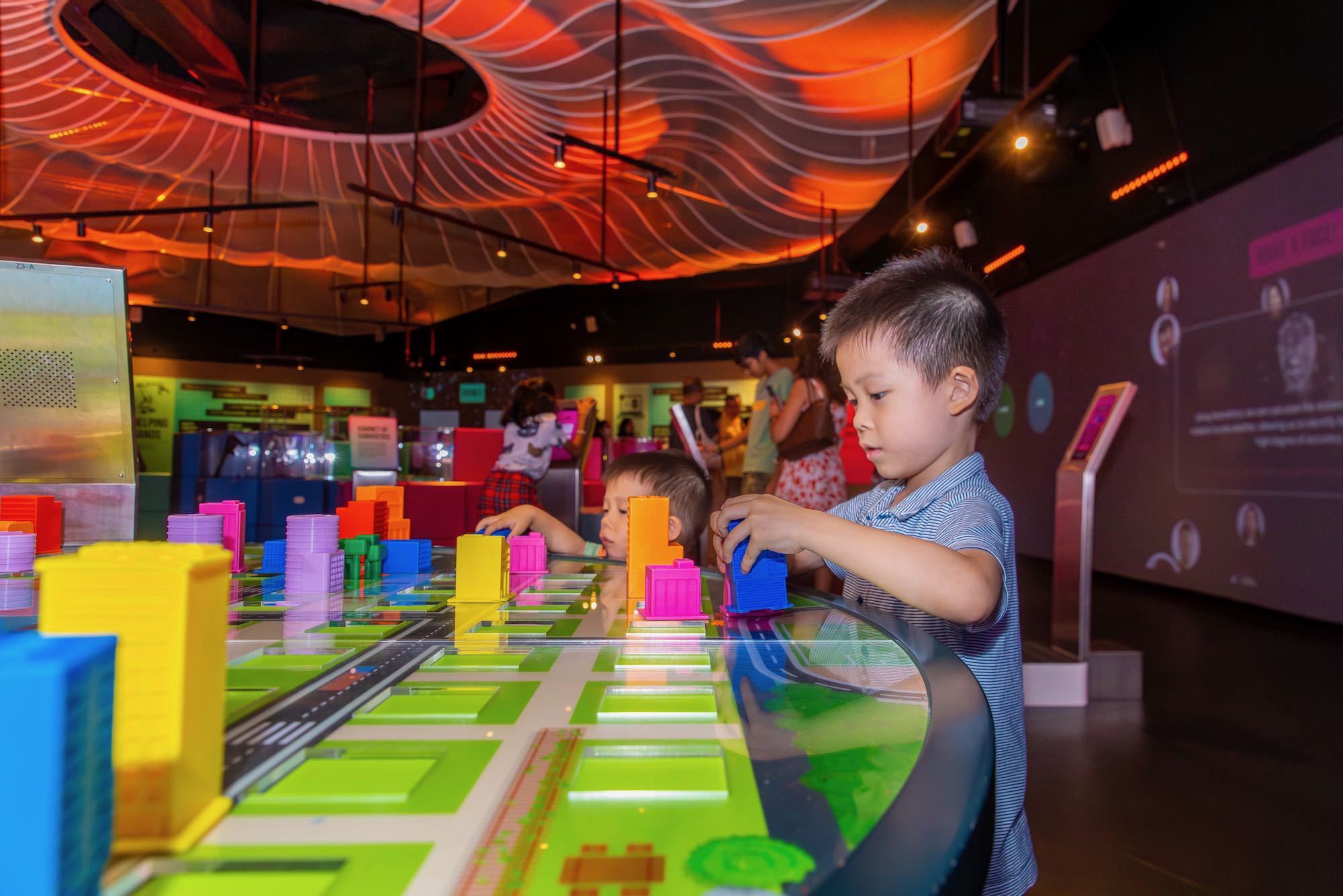 Boy playing with building blocks at an exhibition